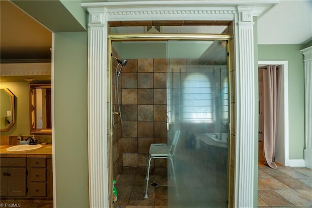 bathroom featuring vanity, crown molding, and tiled shower