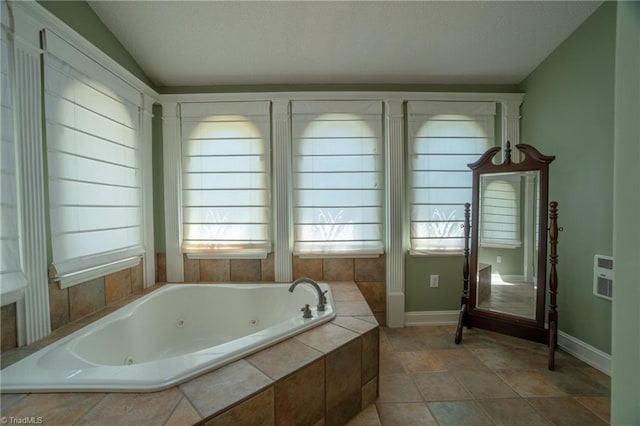 bathroom with a relaxing tiled tub