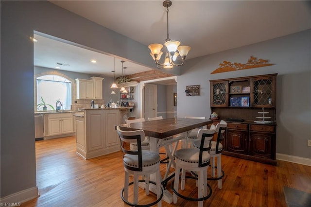 interior space featuring light wood-type flooring and an inviting chandelier