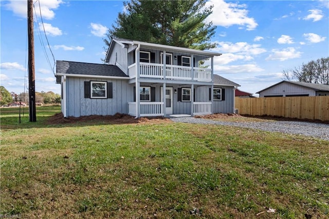 view of front property featuring a front yard, a porch, and a balcony