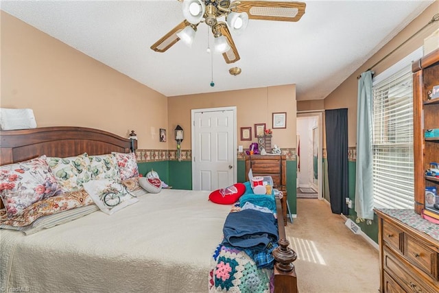 carpeted bedroom with a ceiling fan and baseboards