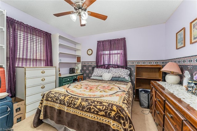 bedroom featuring ceiling fan, carpet flooring, and a textured ceiling