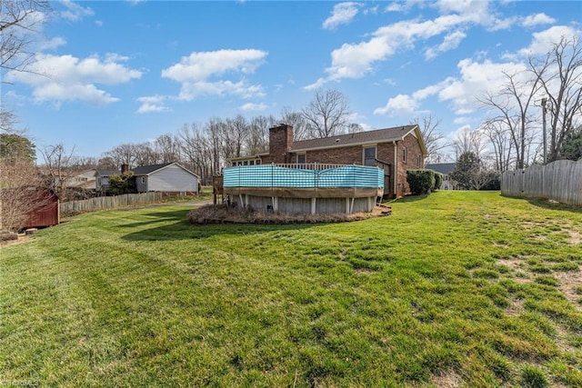 view of yard featuring a wooden deck and fence