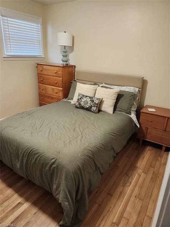 bedroom with wood-type flooring