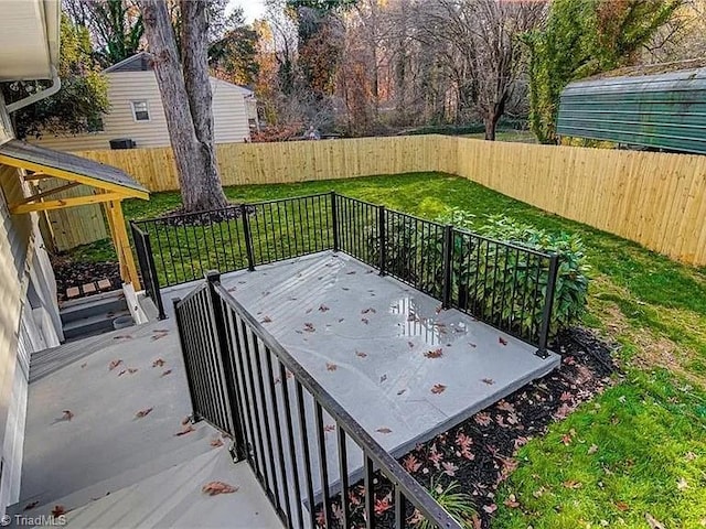 wooden terrace featuring a yard and a fenced backyard