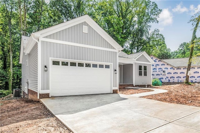 317 Styers Rd, Winston-Salem, NC 27105 - ranch-style house featuring a garage, board and batten siding, crawl space, concrete driveway, and cooling unit