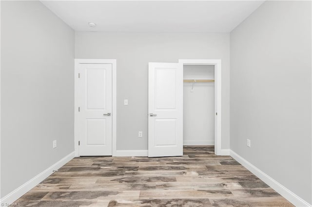 317 Styers Rd, Winston-Salem, NC 27105 - unfurnished bedroom with baseboards, wood finished floors, and a closet