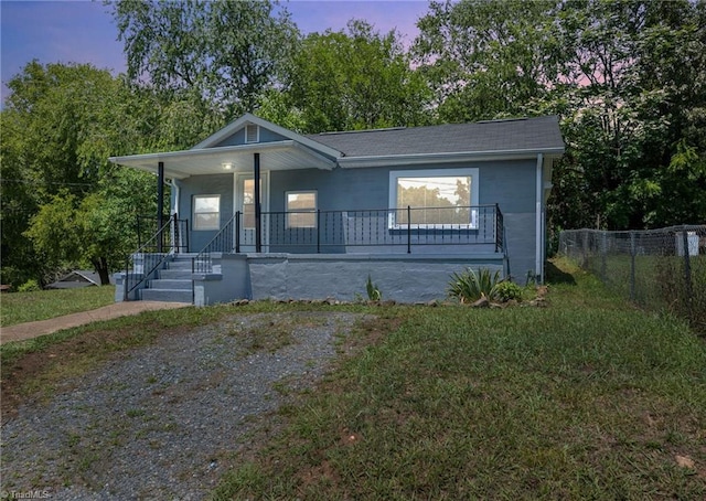 view of front of house with a lawn and covered porch