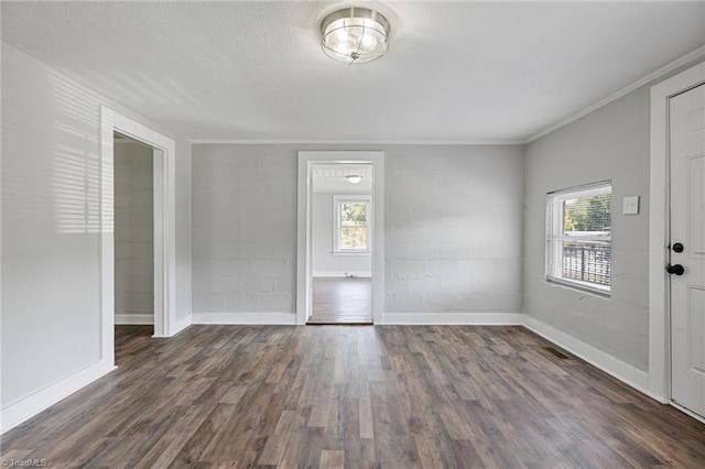 foyer featuring dark hardwood / wood-style flooring and crown molding