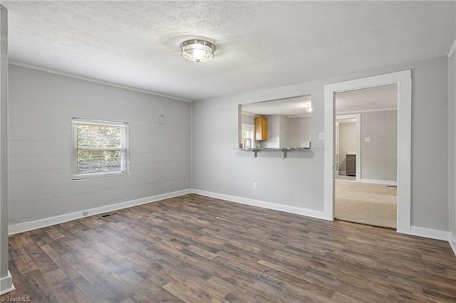 unfurnished room with dark hardwood / wood-style floors and a textured ceiling