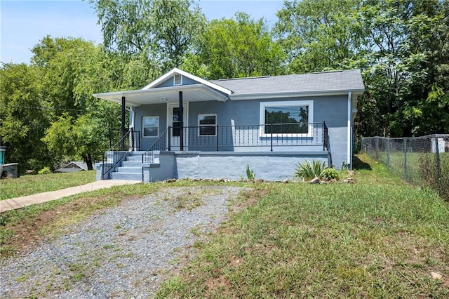 bungalow-style home featuring a porch and a front yard