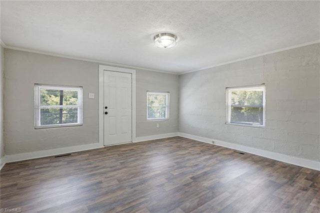 entryway featuring crown molding, dark wood-type flooring, and a textured ceiling