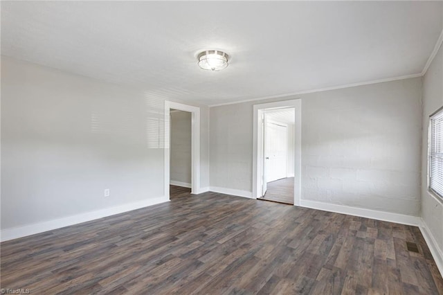 unfurnished room featuring crown molding and dark hardwood / wood-style floors