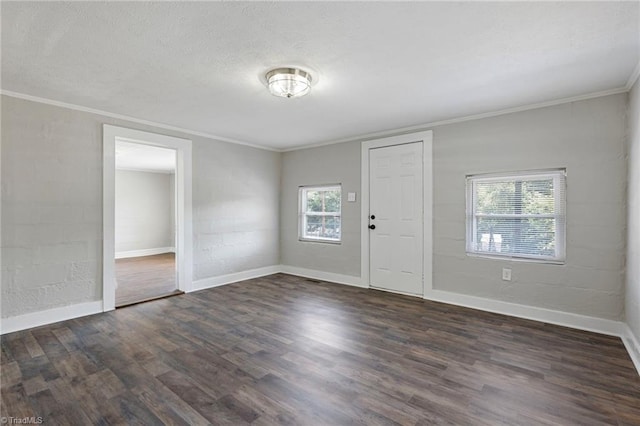 empty room with crown molding and dark hardwood / wood-style flooring