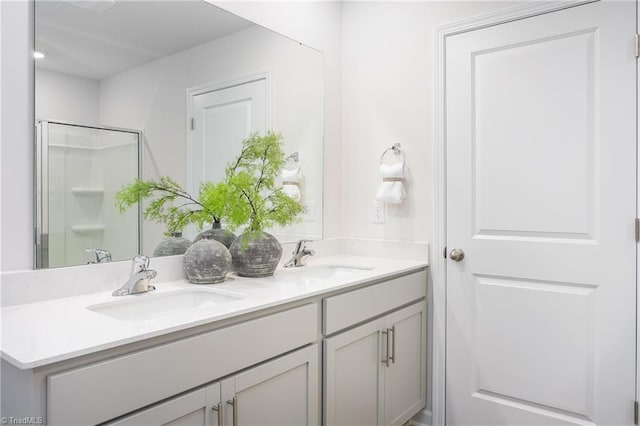 bathroom featuring vanity and a shower with shower door