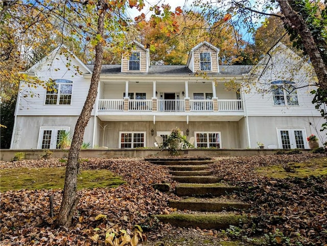 view of front of property with french doors and a balcony