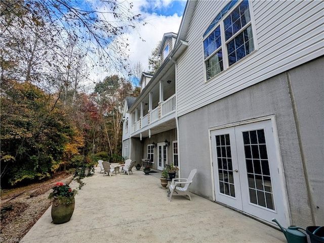 view of patio / terrace with a balcony and french doors