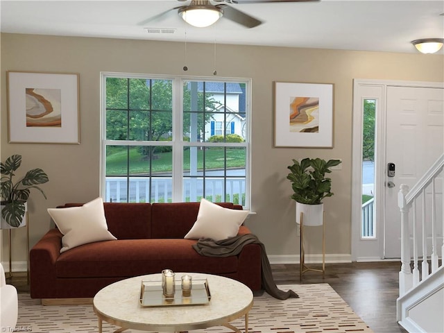 living room with wood-type flooring and ceiling fan