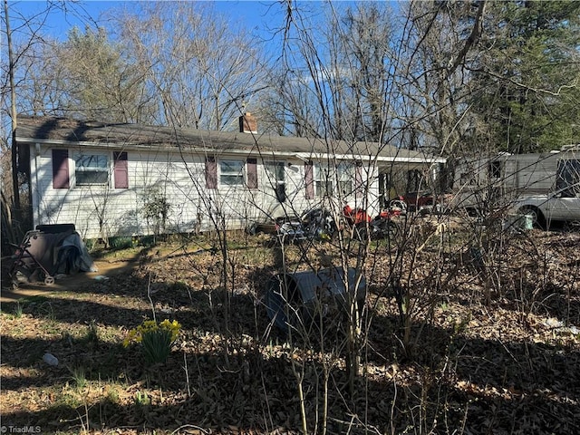 view of property exterior with a chimney