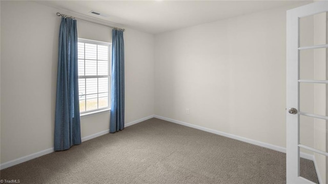 carpeted empty room with baseboards and visible vents