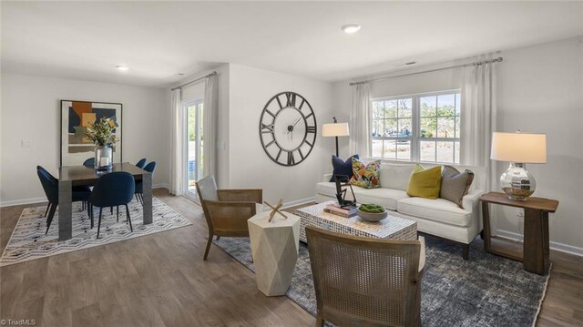living area featuring baseboards and wood finished floors