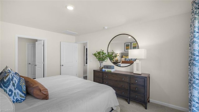 bedroom featuring light carpet and baseboards