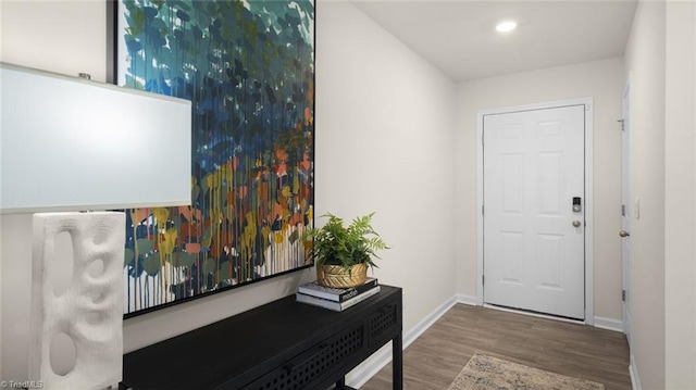 doorway to outside featuring baseboards, wood finished floors, and recessed lighting