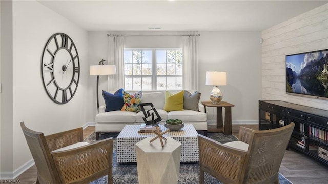 living area with wood finished floors and baseboards