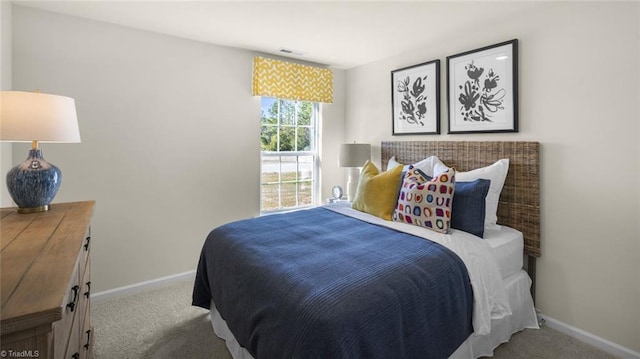 bedroom featuring baseboards, carpet flooring, and visible vents