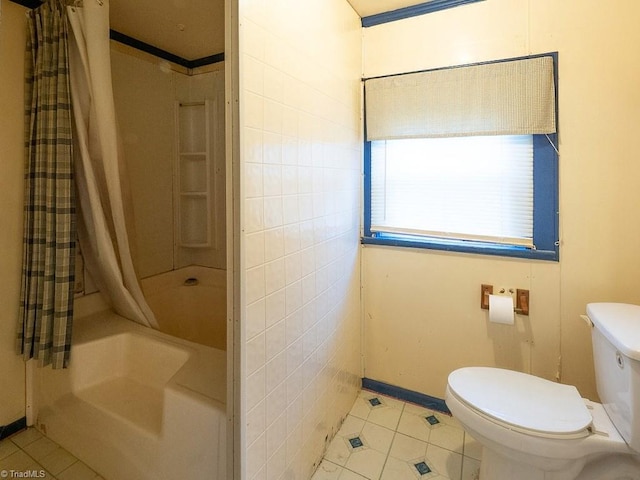 bathroom featuring toilet, shower / tub combo with curtain, tile patterned floors, and tile walls