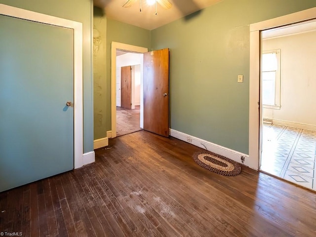 unfurnished bedroom with dark hardwood / wood-style floors and ceiling fan