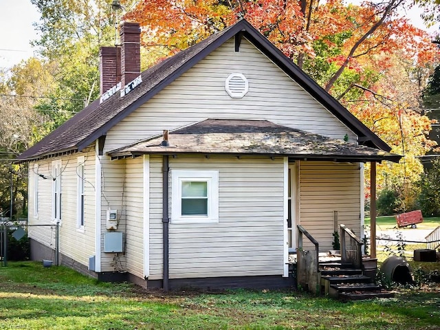 back of house with a lawn