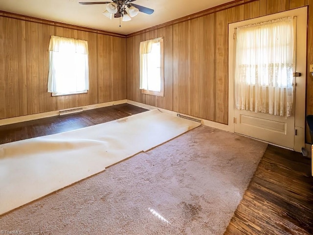 unfurnished room with wooden walls and ceiling fan