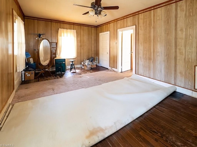 interior space featuring wooden walls, crown molding, and dark hardwood / wood-style floors