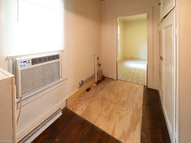 clothes washing area featuring cooling unit and hardwood / wood-style flooring