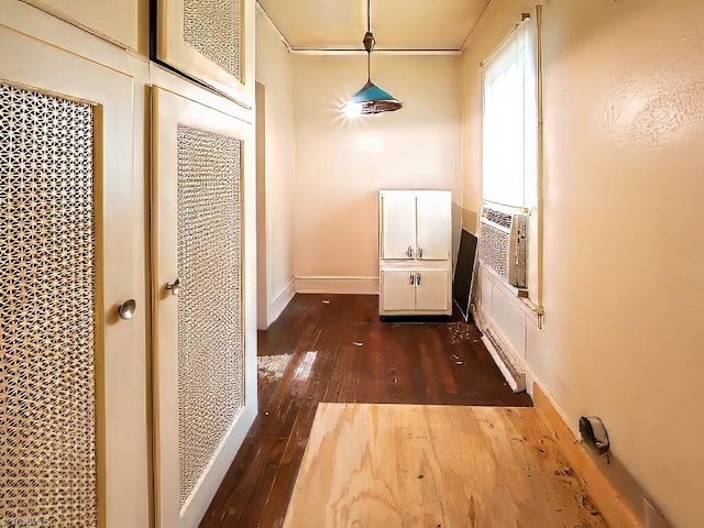 hallway with cooling unit and dark hardwood / wood-style flooring