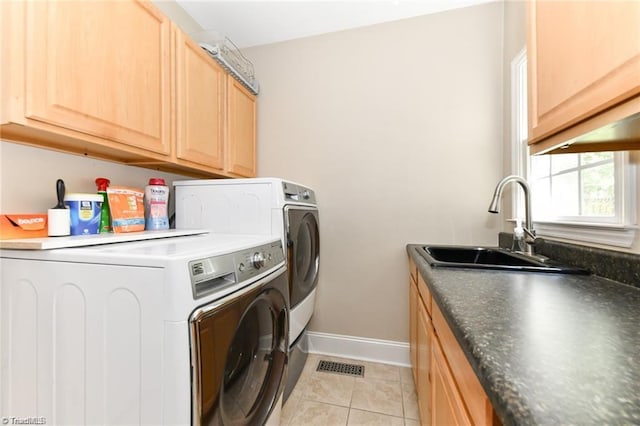 washroom featuring independent washer and dryer, light tile patterned flooring, baseboards, and cabinet space