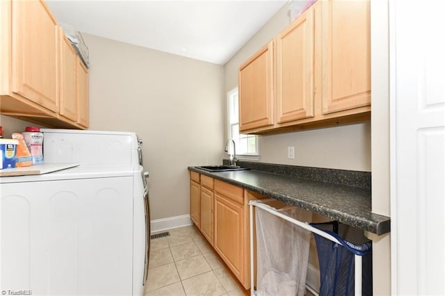 laundry room with washer / dryer, cabinet space, light tile patterned floors, and baseboards