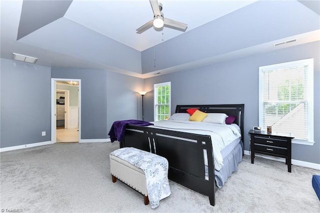 carpeted bedroom featuring baseboards, a ceiling fan, and ensuite bath