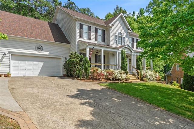 view of front of home with covered porch, concrete driveway, a garage, a front yard, and roof with shingles