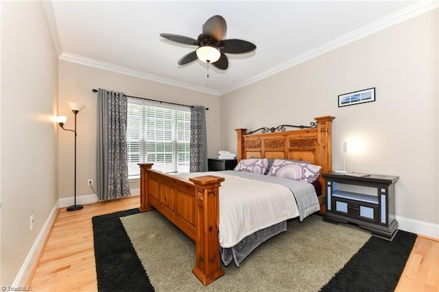 bedroom featuring crown molding, light wood-style floors, baseboards, and ceiling fan