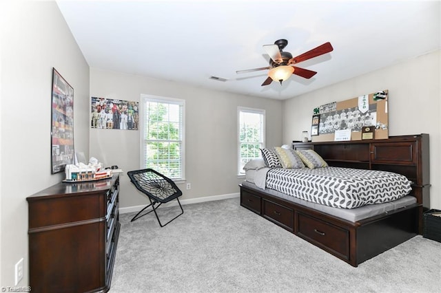 bedroom with light carpet, baseboards, and a ceiling fan