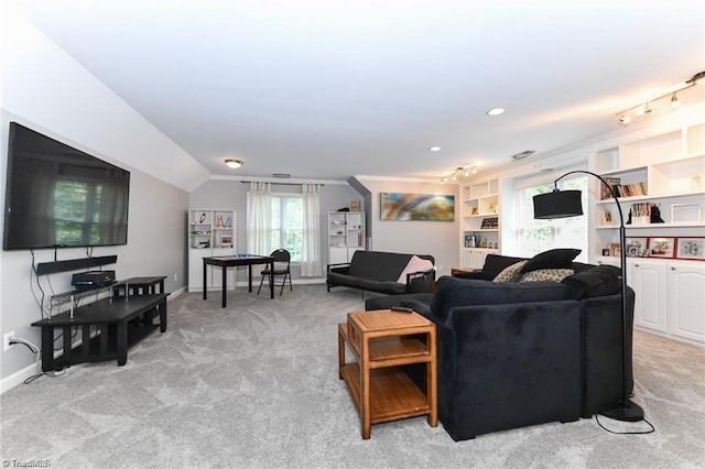 living area featuring baseboards, light carpet, and vaulted ceiling