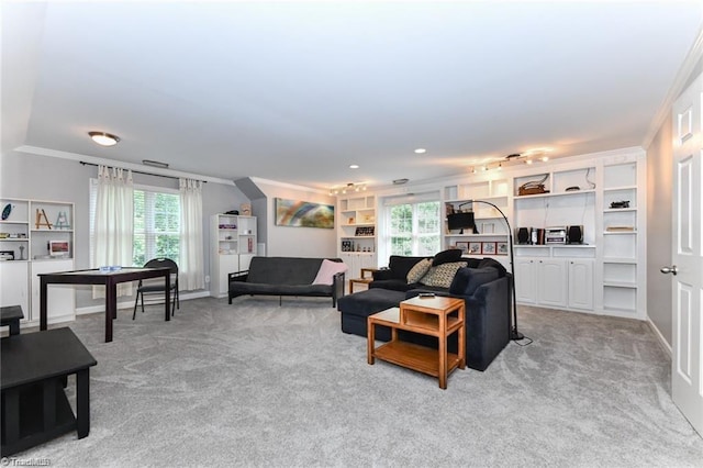 living area featuring crown molding, light colored carpet, and healthy amount of natural light