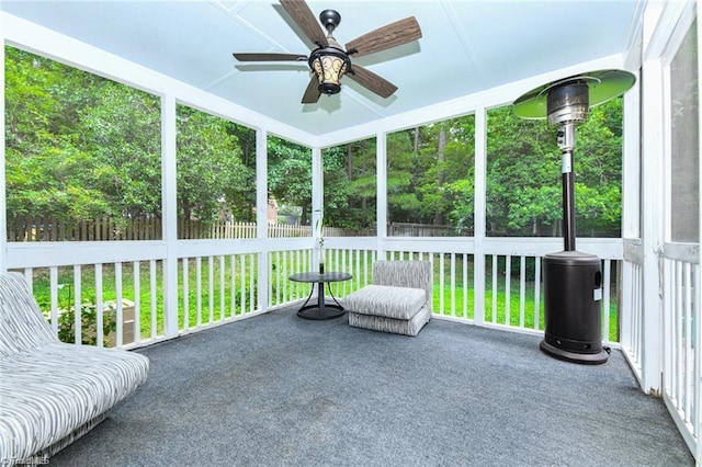 unfurnished sunroom with a ceiling fan