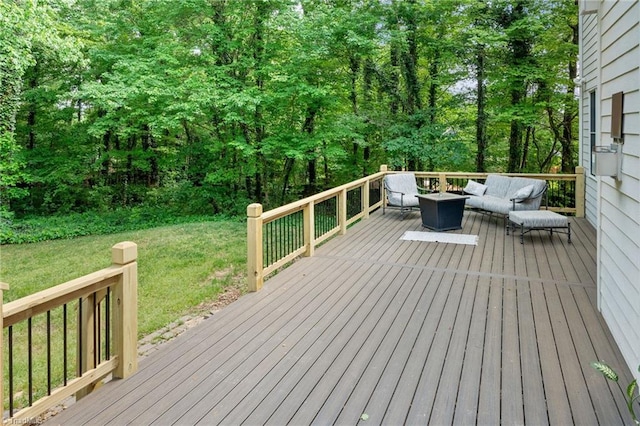 deck with a yard and a fire pit
