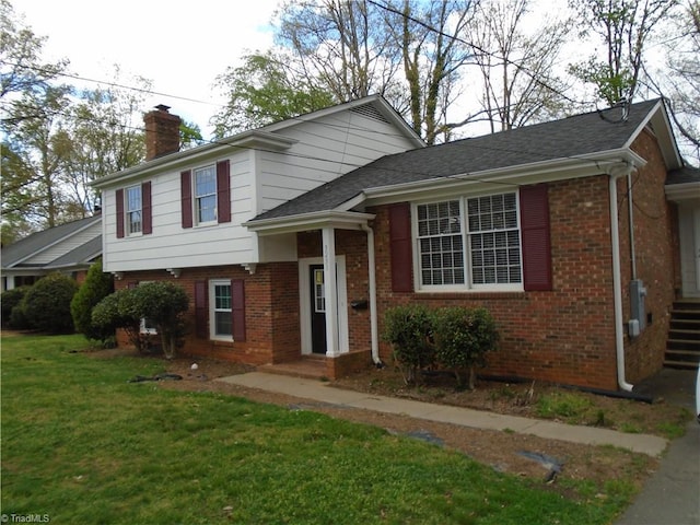 split level home featuring a front lawn