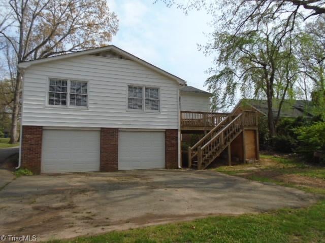 view of front of house with a deck and a garage