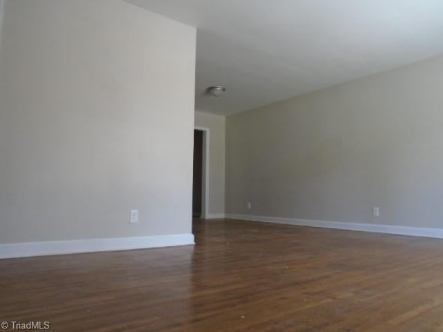 empty room featuring dark hardwood / wood-style floors