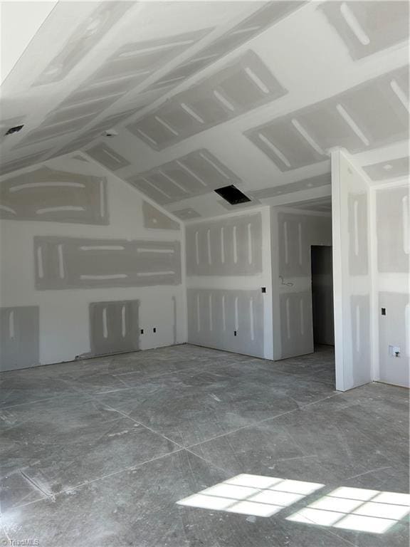 spare room featuring lofted ceiling